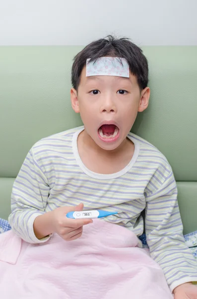 Boy feel exciting after looking at thermometer — Stock Photo, Image