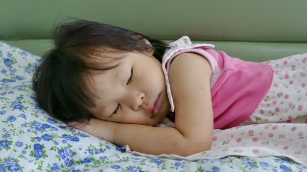 Cute little girl sleeping on sofa bed — Stock Video