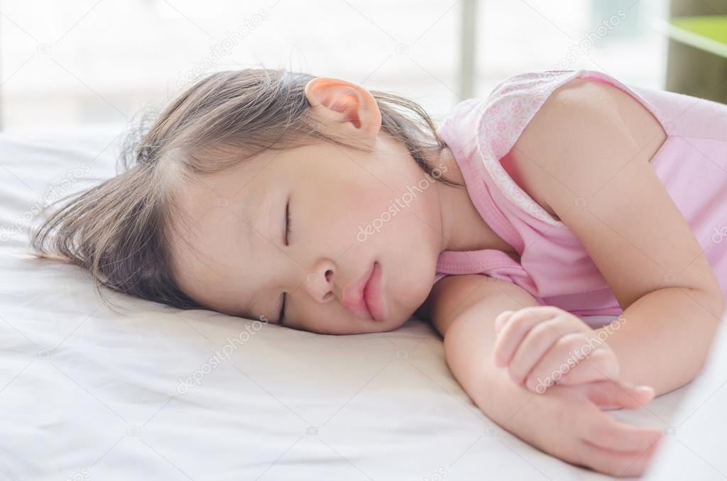 girl sleeping on bed