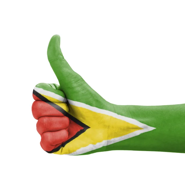 Hand mit erhobenem Daumen, Guyana-Flagge als Symbol der Exzellenz bemalt, — Stockfoto