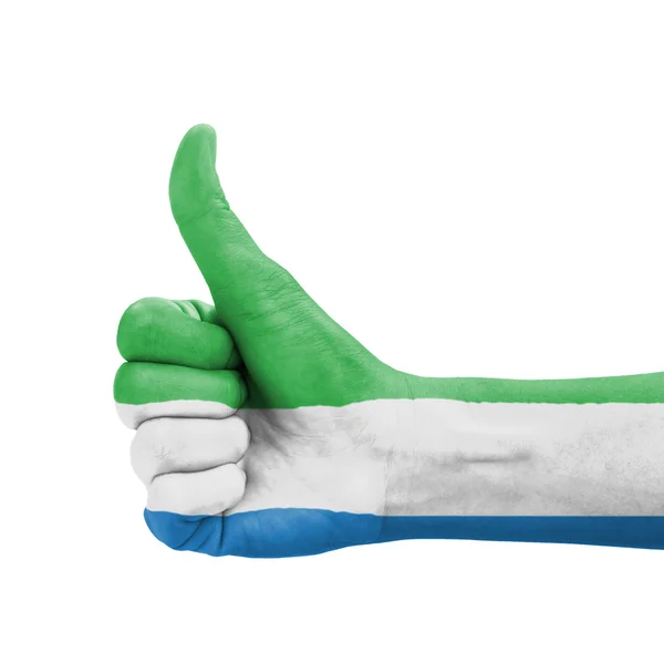 Рука с большим пальцем вверх, флаг Сьерра-Леоне, нарисованный как символ превосходства — стоковое фото