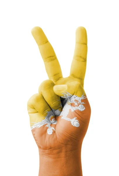 Hand making the V sign, Bhutan flag painted as symbol of victory — Stock Photo, Image