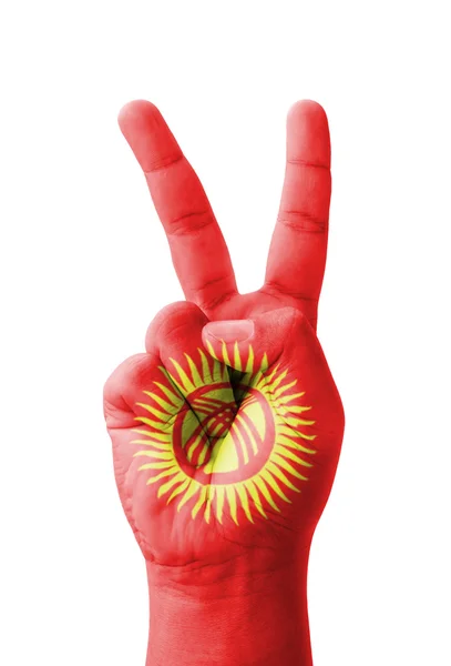 Hand making the V sign, Kyrgyzstan flag painted as symbol of vic — Stock Photo, Image