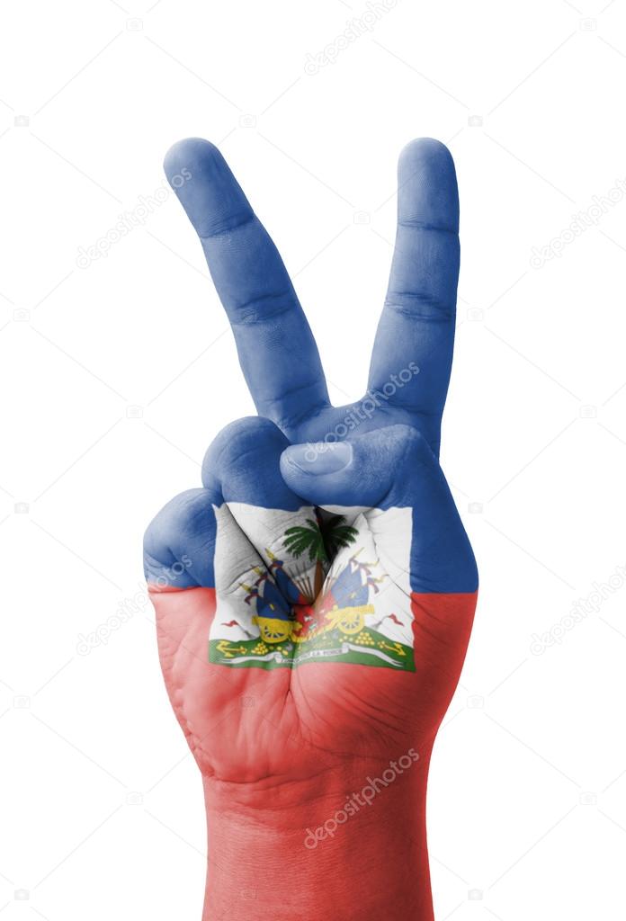 Hand making the V sign, Haiti flag painted as symbol of victory,