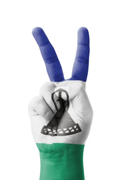 Hand making the V sign, Lesotho flag painted as symbol of victor — Stock Photo, Image