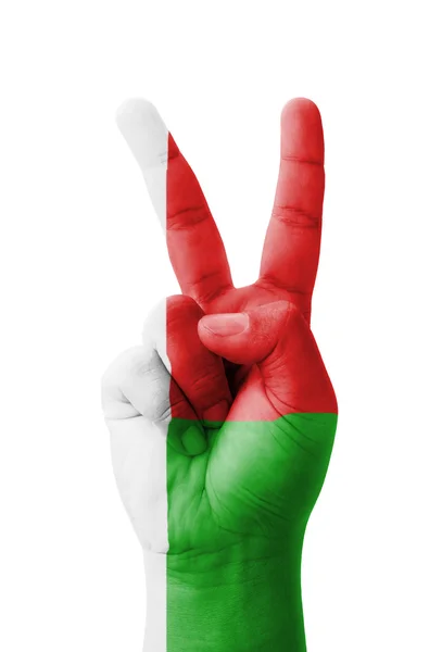 Hand making the V sign, Madagascar flag painted as symbol of vic — Stock Photo, Image