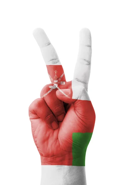 Hand making the V sign, Oman flag painted as symbol of victory, — Stock Photo, Image