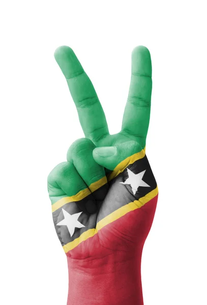 Hand making the V sign, Saint Kitts and Nevis flag painted as sy — Stock Photo, Image