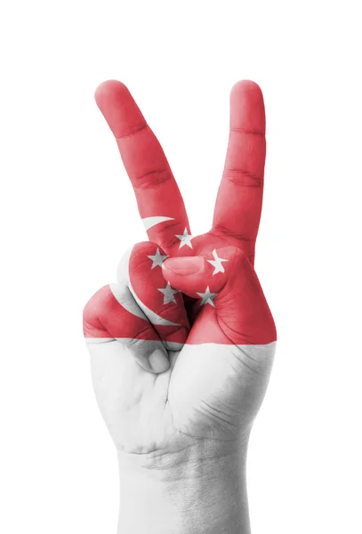 Hand making the V sign, Singapore flag painted as symbol of vict — Stock Photo, Image