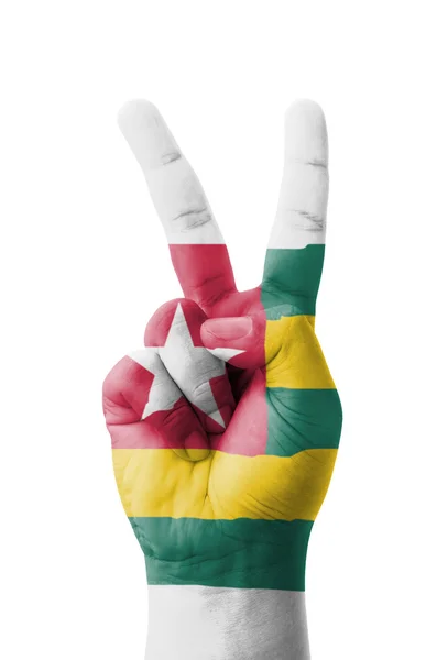 Hand making the V sign, Togo flag painted as symbol of victory, — Stock Photo, Image