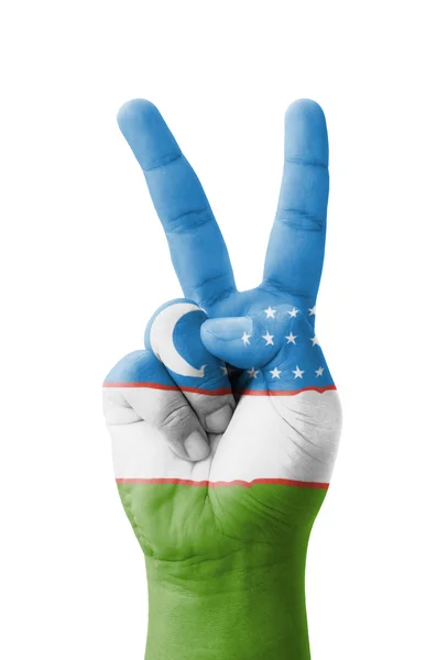 Ręka Dokonywanie znak V, flaga Uzbekistanu malowane jako symbol vic — Zdjęcie stockowe