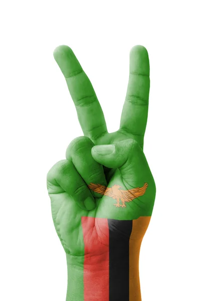 Hand making the V sign, Zambia flag painted as symbol of victory — Stock Photo, Image