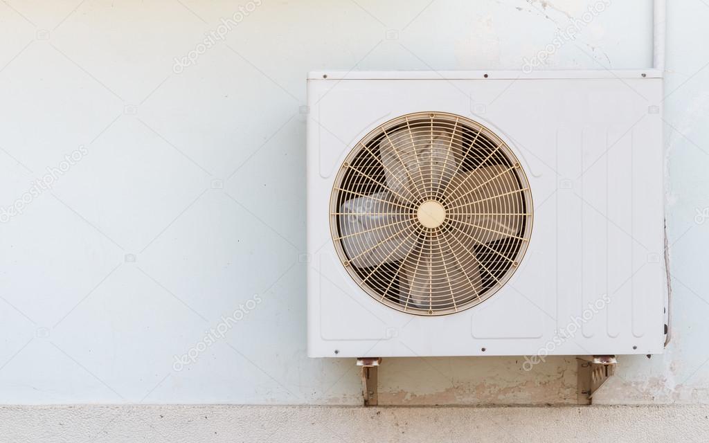 Old air compressor is located outside office building Stock Photo by
