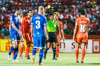 SISAKET THAILAND-AUGUST 13: The referee (green) show a yellow ca
