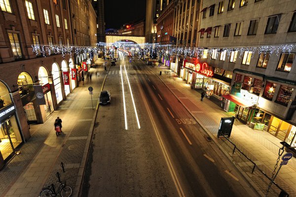 Stockholm, Sweden - December 7, 2013: Night traffic on Kungsgatan in central Stockholm. Cars, pedestrians, taxis in traffic close to the crossing with Sveavagen.