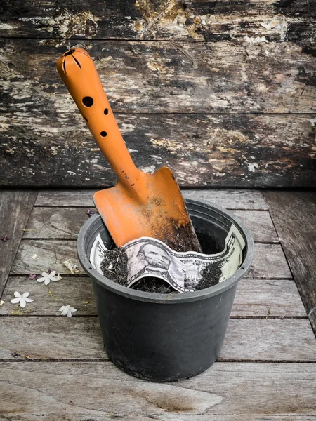 Shovel and flowerpot of American dollar — Stock Photo, Image