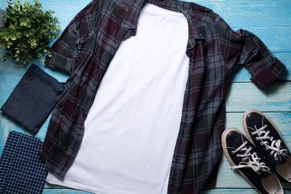 Mockup of a gray t-shirt blank shirt template with accessories on the table background, lifestyle and travel concep