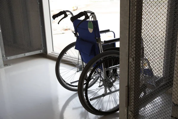 Empty wheelchair parked in airport