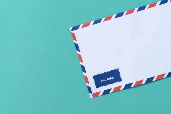 Air mail envelope on green background, communication concept