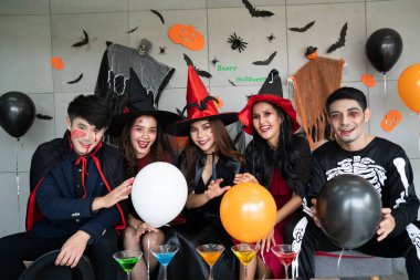 Genç Asyalı insanlar, beş kişilik bir grup, korkunç kostümler içinde. Cadılar Bayramı kıyafetleri giyen bir grup arkadaş bir partiye katılmaya hazırlanıyor.. 