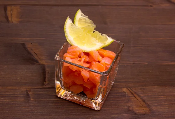 Cubes of smoked salmon on wood