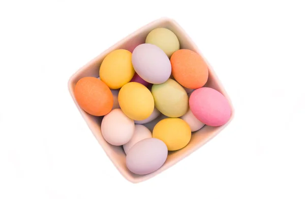Colored eggs on top square bowl — Stock Photo, Image