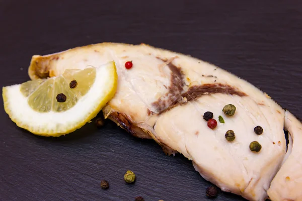 Slice of swordfish on slate close up view — Stock Photo, Image