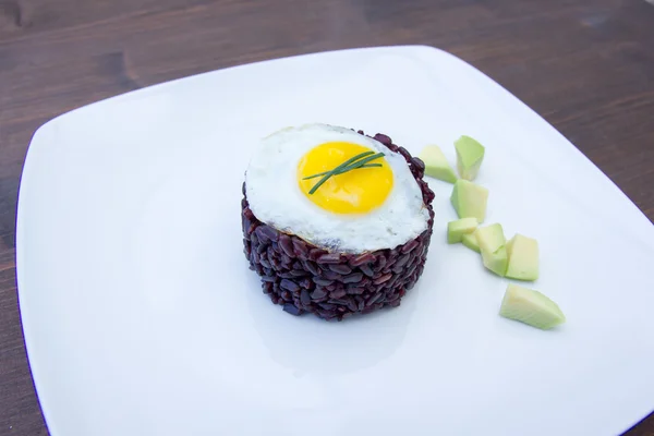 Arroz negro con huevo de codorniz en madera visto de cerca — Foto de Stock