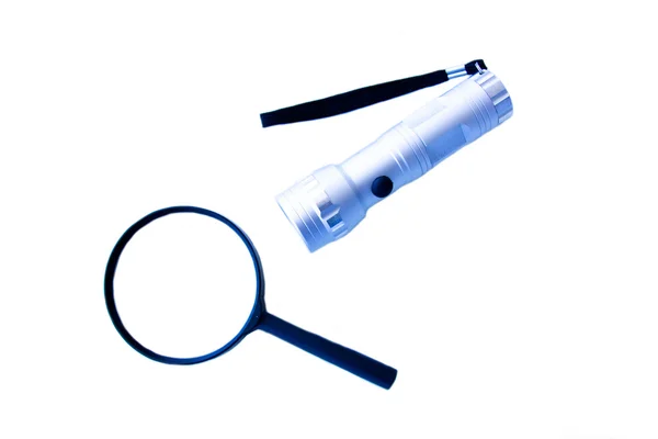 Magnifying glass and flashlight from above — Stock Photo, Image
