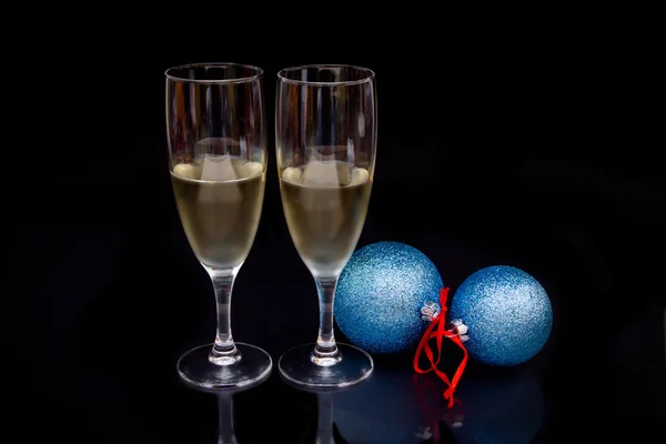 Flauta com espumante e bolas de Natal em preto — Fotografia de Stock