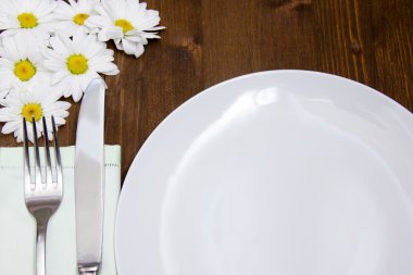 Cutlery and plate with flowers close up