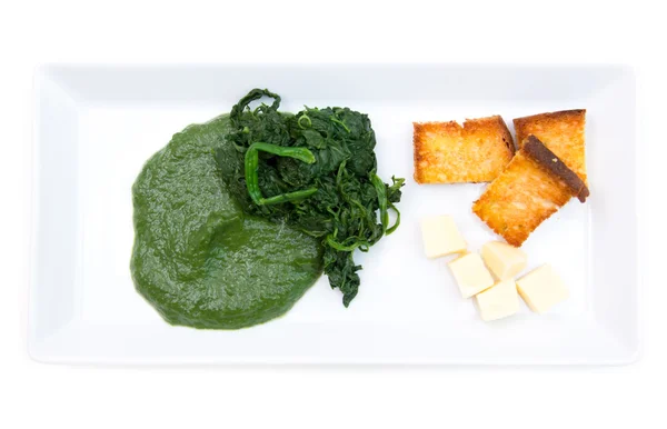 Tray with creamed spinach and croutons from above — Stock Photo, Image