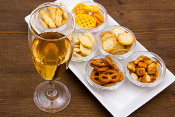 Flute with aperitif and pretzels — Stock Photo, Image