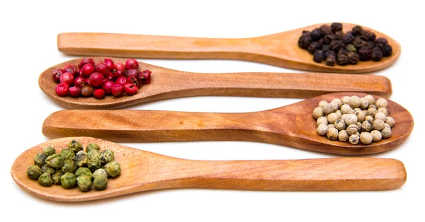Wooden spoons with mixed peppers — Stock Photo, Image