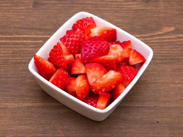 Strawberries on square bowl on wood — Stock Photo, Image