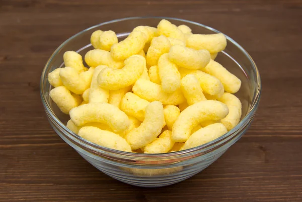 Corn snacks on bowl on wood — Stock Photo, Image
