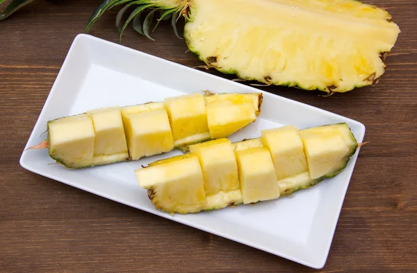 Slice of pineapple cut on wood from above — Stock Photo, Image