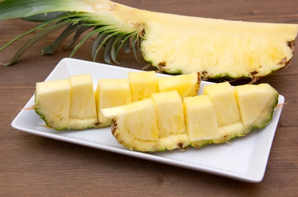 Slice of pineapple cut on wood — Stock Photo, Image