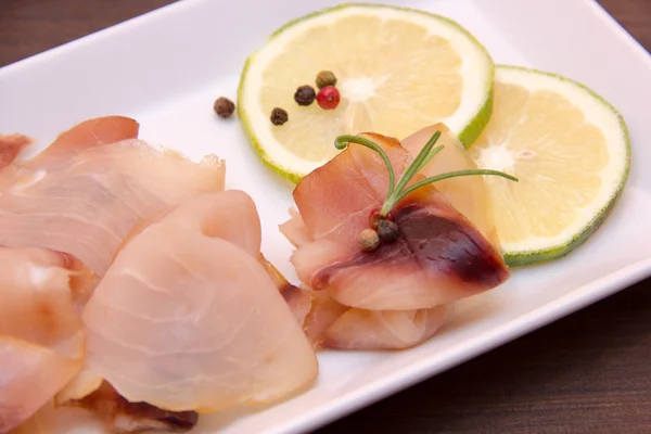 Smoked swordfish on tray on wood from very close — Stock Photo, Image