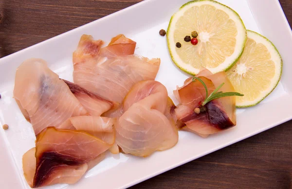 Smoked swordfish on tray on wood seen from above and close — Stock Photo, Image