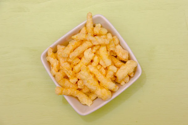 Snack corn cheese in square bowl on green top — Stock Photo, Image