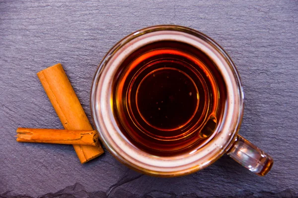 Herbal tea with cinnamon on top slate — Stock Photo, Image