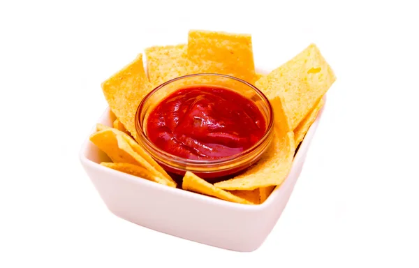 Bowl with corn chips and hot sauce — Stock Photo, Image