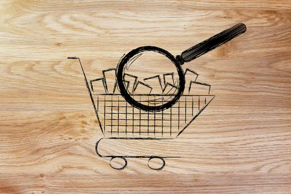 Magnifying glass analyzing a shopping cart full of items — Stock Photo, Image