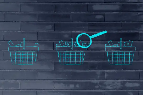 Magnifying glass on shopping baskets with different amount of it — ストック写真
