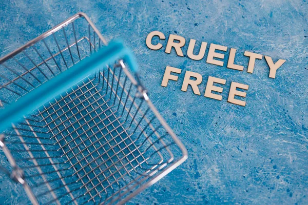 Vegan products and animal rights concept, Cruelty Free text on blue background with shopping cart