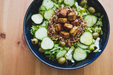 sağlıklı bitkisel yemek tarifleri, vejetaryen çünkü kinoalı marul salatası ve zeytin ve salatalıklı terbiye edilmiş tofu ısırığı.