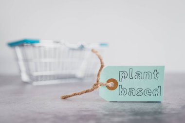 Market alışveriş sepetli bitkisel ürün etiketi, sağlıklı beslenme konsepti ve etik seçimler