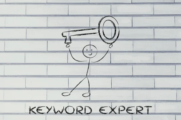 Man holding oversized key, keyword expert — Stock Photo, Image
