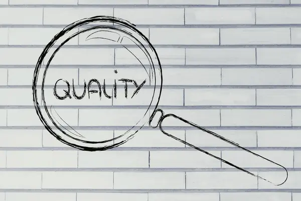 Magnifying glass focusing on quality — Stock Photo, Image